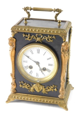 A late 19thC gilt metal and ebonised mantel clock, with enamel 9cm diameter Roman numeric dial in an elaborate case raised with garland and with figure head embellishment on scroll feet, eight day movement, 22cm high.