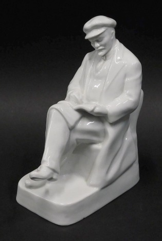 A Dulevo style undecorated porcelain figure of Lenin, seated reading, unmarked, 22cm high.