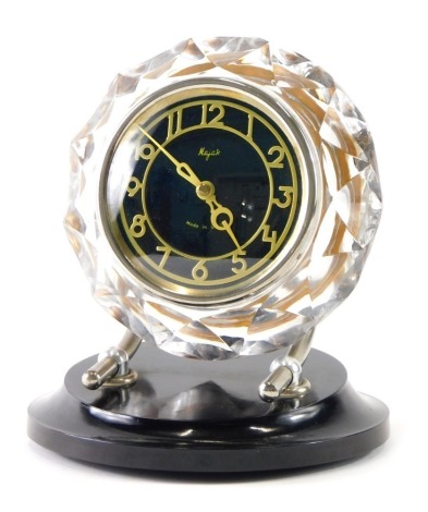 A Majak USSR clock, with 9cm diameter Arabic dial, on chrome mounts and ebonised socle, 24cm high.