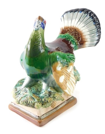 A Konakov figure of a capercaillie, on naturalistic base, polychrome decorated, marked beneath, 29cm high.