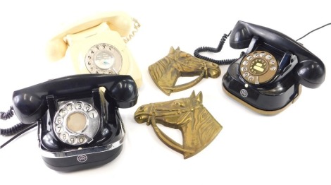 A FTR marked telephone, with front articulated dial, in black with gilt stencilling, 15cm wide, a cream telephone, brass horse wall hangings, etc. (a quantity)