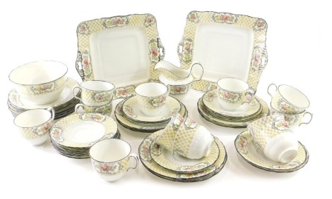 A 19thC pottery part tea service, florally decorated with a lattice floral border, to include serving plate, 24cm wide, cups, saucers, slop bowl, etc. (a quantity)