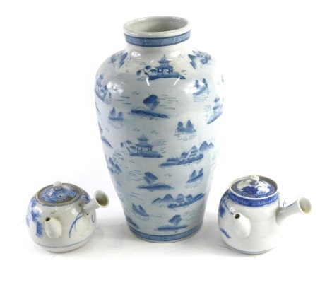 An Oriental porcelain blue and white vase, decorated with landscapes, etc., and two Japanese sake pots, 8cm high. (3)