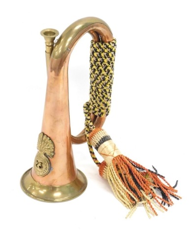 A 20thC copper and brass bugle, with Royal Welsh Fusilier's emblem, 27cm high.