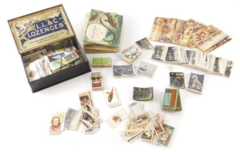 Various cigarette, trade and other cards, Brooke Bond tea cards, albums, a tin containing various part sets, Churchman The King's Coronation, small quantity of Battles for the Flag The King's Regiment Wizard postcards, pirate's keg Helm Royal, box contain