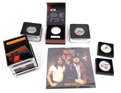 An AC/DC uncirculated silver record case coin set, with Highway To Hell record, an AC/DC Black Ice cased coin, a further AC/DC coin and various other AC/DC related Razor's Edge and other medallions, coins, etc. (a quantity)