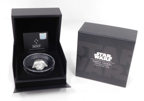 A Star Wars Darth Vader premium helmet 2oz silver coin, with paperwork and outer box.