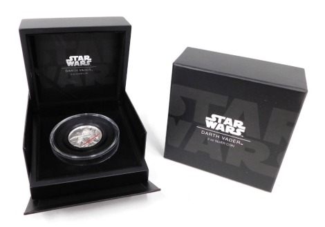 A Star Wars Darth Vader 2oz silver coin, with box and some paperwork.