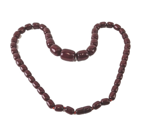 A graduated red bead necklace, 72cm long, the largest bead approx 3cm wide.