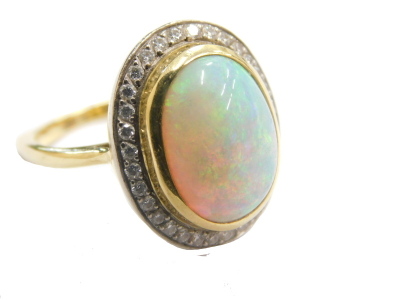 An opal dress ring, the oval stones surrounded by small diamonds, on a part pierced shank, marks pitted, size L, 7.4g all in.