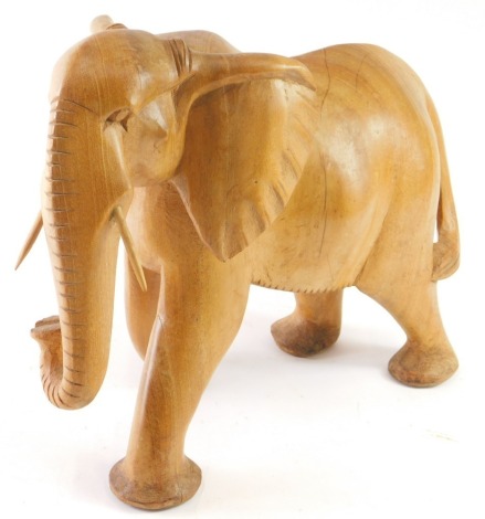 A carved wooden model of an elephant, 32cm high.