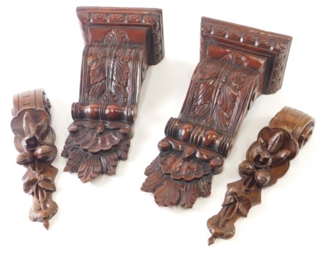 A pair of wooden scroll floral mouldings, and a pair of carved wall shelves, 39cm high. (4)