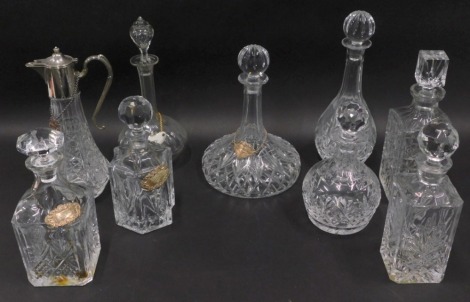 Various cut glass crystal and other decanters, a spirit jug with plated mounts, and spirit label, a silver brandy spirit label, ship decanter, 33cm high, etc. (a quantity)