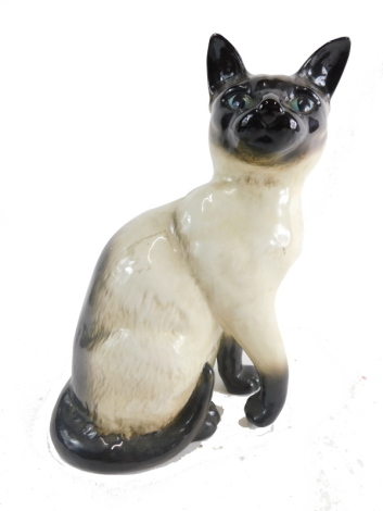 A Beswick figure of a standing cat, with blue eyes, numbers 1882, impressed marks beneath, 26cm high.