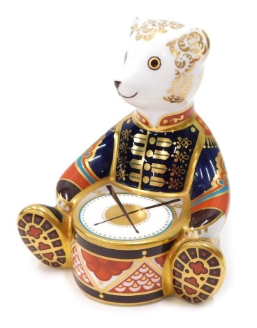 A Royal Crown Derby paperweight ornament Drummer Teddy Bear, gilt stopper, printed marks beneath, 11cm high.