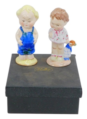 A Shelley China Club limited edition figure group, child with doll and child in dungarees, printed marks beneath, 13cm high. (2, boxed)