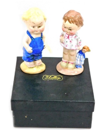 A Shelley China Club limited edition figure group, child with doll and child in dungarees, printed marks beneath, 13cm high. (2, boxed)