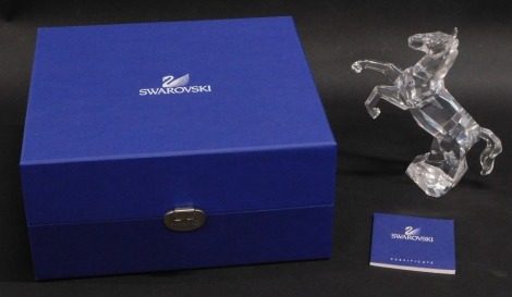 A Swarovski crystal figurine prancing stallion, 16cm high, boxed with paperwork.