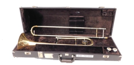 A Sovereign one piece brass tenor trombone, with two mouthpieces. (one piece, cased)