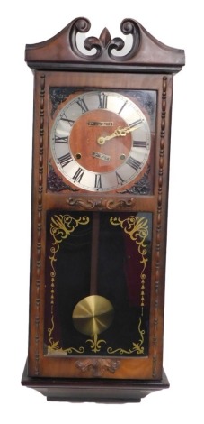 A walnut cased President thirty one day mantel clock, the Roman numeric dial fronted by a glazed door, 67cm high.