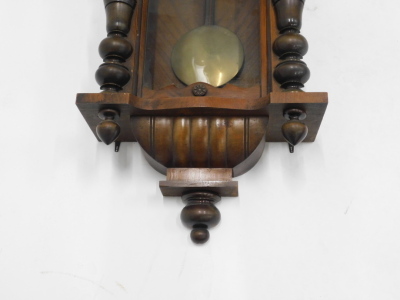 A late 19thC Gustav Becker walnut cased double weight Vienna clock, of large proportion, with eagle finial, raised above 18cm diameter Roman numeric dial, with subsidiary Arabic second hand, flanked by quarter columns, with pendulum and two weights, 114cm - 3