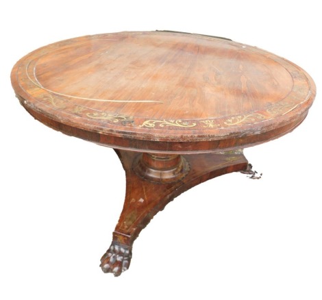 A George IV rosewood and brass inlaid breakfast table, with a circular top, on a tapering cylindrical column and concave platform, with carved paw feet, 130cm diameter, 71cm high. This lot is located at Oundle, Near Peterborough, PE8, viewing and collecti