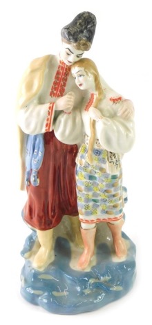 A Ukrainian Polonoye figure group, marked beneath, 26cm high.