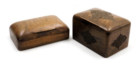 An early 20thC Middle Eastern olive wood cigarette box, with carved foliate decoration, opening to reveal three compartments for cigarettes, 15cm wide, and a further cigarette box, of domed form, the hinged lid opening to reveal a two division interior, 1