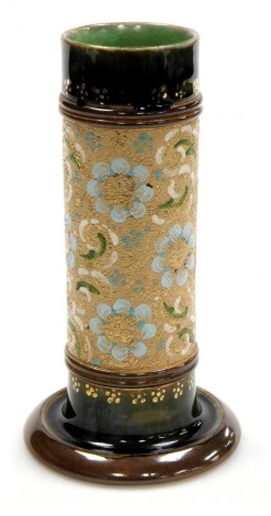 A late 19thC Royal Doulton stoneware chine spill vase, with floral decoration on a green ground, impressed and incised marks, 19cm high.