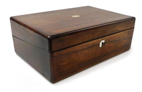 A Victorian rosewood writing slope, with mother of pearl escutcheon, opening to reveal a slope, and fitted compartments, with inkwell and pounce pot, 13cm high, 35.5cm wide, 23cm deep.