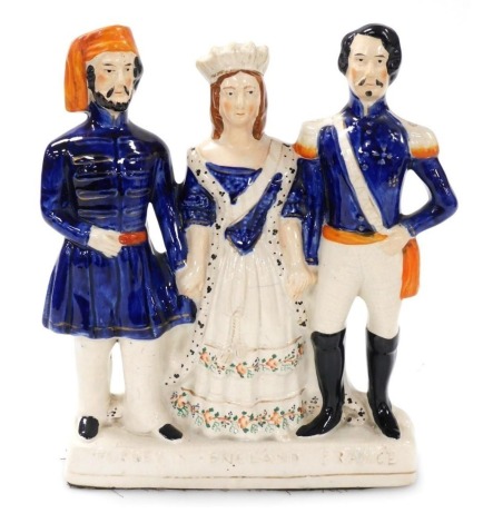 A late 19thC Staffordshire flatback figure group, modelled as the Sultan of Turkey, Queen Victoria of England, and the Emperor Napoleon III of France, emblematic of Turkey, England and France, 28cm high.