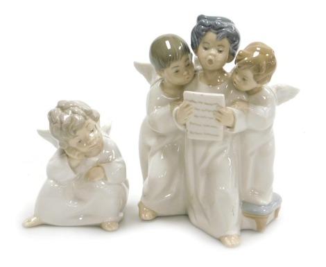 A Lladro porcelain figure of three cherubs, singing from a music sheet, and a further figure of a cherub, modelled seated with his hand on his cheek. (2)