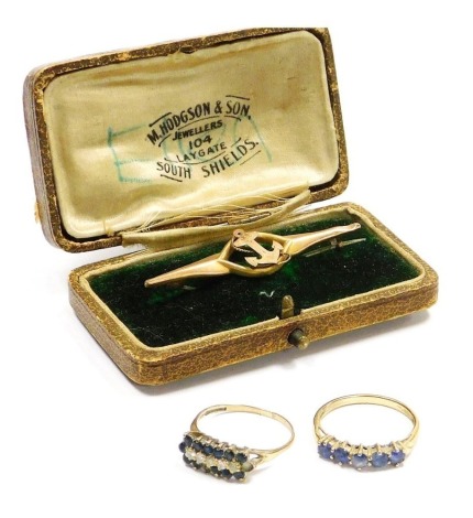 A 9ct gold and pale blue five stone ring, possibly sapphires, size P1/2, a 9ct gold and diamond five stone ring, in a surround of sapphires, two sapphires lacking, size P, and a Victorian 9ct rose gold maritime sweetheart brooch, formed centrally with a f