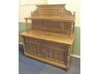 A Victorian oak side cabinet in the Arts & Crafts style with a panelled