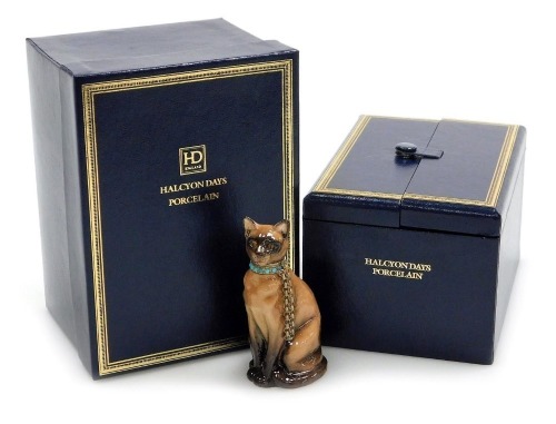 A Halcyon Days porcelain and silver gilt mounted scent bottle, modelled as a Burmese cat, the collar inset with turquoise stones, 7cm high, boxed with outer box.