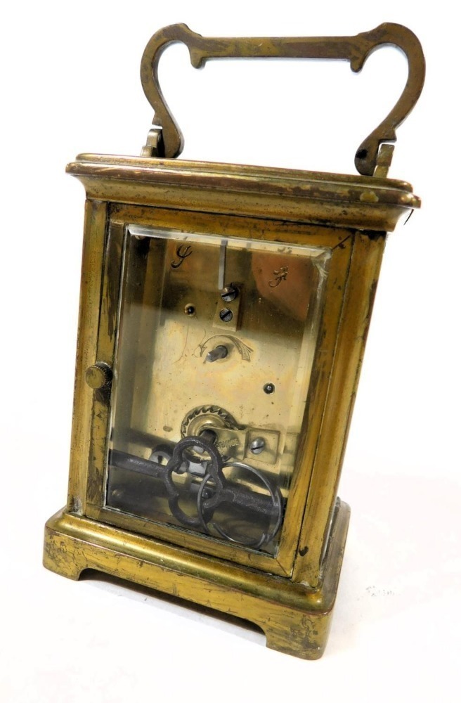 An early 20thC brass cased carriage clock, rectangular enamel dial ...
