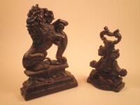 A Victorian cast iron doorstop in the form of a lion and another cast iron doorstop (2)