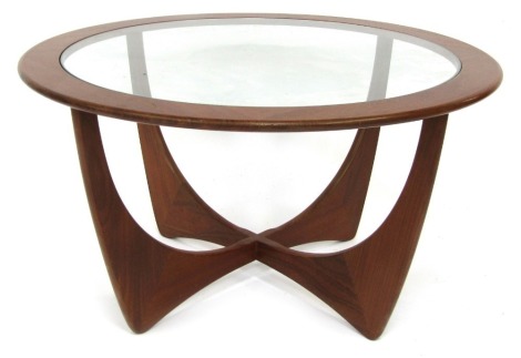 A mid century G-Plan teak Astro coffee table, the circular top inset with a glass panel above two inter-crossed U section supports, 44cm high, the top 83cm diameter.