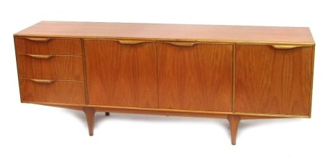 A mid century A H McIntosh Ltd. teak sideboard, the rectangular top above two doors, flanked by a fall and three further drawers, on four tapering legs, bears label, 74cm high, 200cm wide, 45cm deep.