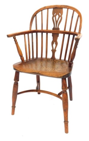 A 19thC yew and elm Windsor chair by Amos of Grantham, with a pierced splat and spindle back, solid saddle seat, stamped 'AMOS' to the rear of the seat, raised on turned legs united by a crinoline stretcher, 56cm wide.