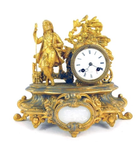 A 19thC French gilt metal mantel clock, the enamel Roman numeric dial for Henry Marc Paris, eight day movement, the case surmounted by a figure in 18thC dress holding staff before a fence, on an elaborate scroll and foliate cast base, with key and pendulu