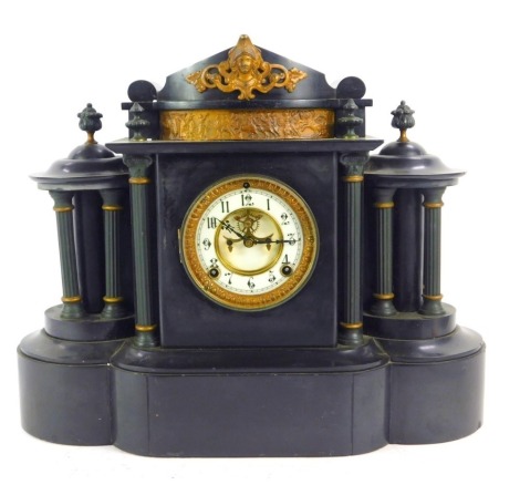 A 19thC black slate mantel clock, with Arabic numeral dial, enamelled chapter ring, eight day movement, the case of architectural form, in classical style, the central section raised with Corinthian column pilasters, the top cast with bust of a Roman warr