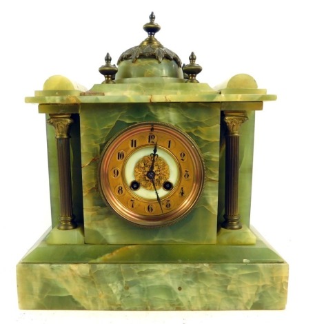 A 19thC green onyx and gilt metal mounted mantel clock, with a Arabic numeral dial, brass chapter ring, eight day, with a French movement number 1202, the case of architectural form, surmounted by gilt metal dome, raised on Corinthian column pilasters, on