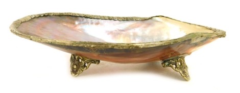 A mother of pearl shell dish, with a reeded and plated outer border, on tripod base, 19cm wide.