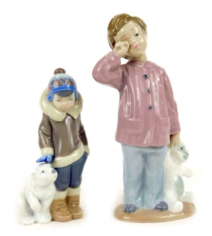 A Lladro figure of a boy in winter clothing with Polar Bear, 15cm high, and a Nao figure of a young boy carrying bear, 20cm high. (2)