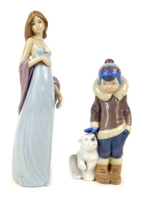 Two Lladro figures, comprising a young boy in winter coat with Polar Bear, 14cm high, and a lady in flowing evening dress, 21cm high. (2)