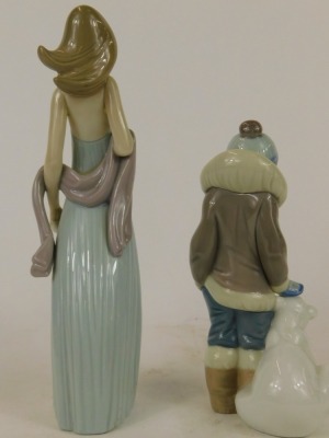 Two Lladro figures, comprising a young boy in winter coat with Polar Bear, 14cm high, and a lady in flowing evening dress, 21cm high. (2) - 2