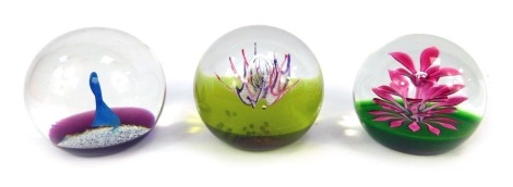 Three glass paperweights, comprising Caithness Antennae, limited edition number 62/750, Caithness Ice Flame 165/1000, and Floral Fountain 182/750. (3)