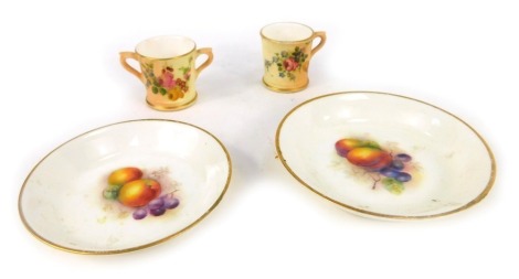 Four items of Royal Worcester blush ivory, comprising two Fruits of the Bloom pin dishes, 10cm and 8.5cm diameter, and two miniature blush ivory cups. (4)