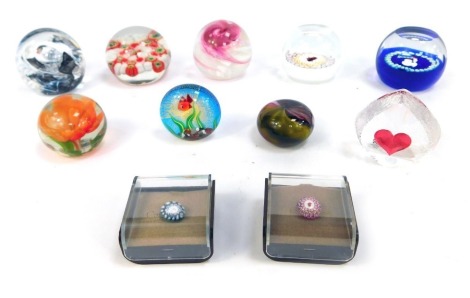 A collection of small glass paperweights, comprising two Caithness miniature Millefiori paperweights, boxed, a Merlin Glass pink swirl, Caithness miniature ladybird, Mats Johansson Swedish Heart weight, Caithness Moon Crystal, Uredale Glass, Murano fish p